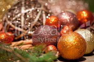 glittering christmas decoration in orange and brown natural wood