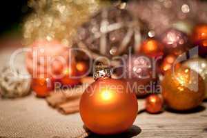 glittering christmas decoration in orange and brown natural wood