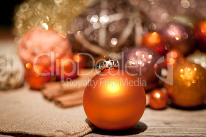 glittering christmas decoration in orange and brown natural wood