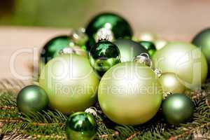 shiny green christmas baubles closeup macro and tree