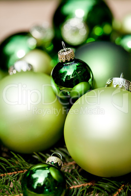 shiny green christmas baubles closeup macro and tree