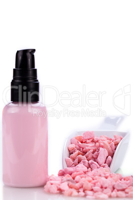 pink body lotion in dispenser and aroma salt isolated