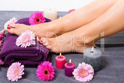 Bare feet of a woman surrounded by flowers