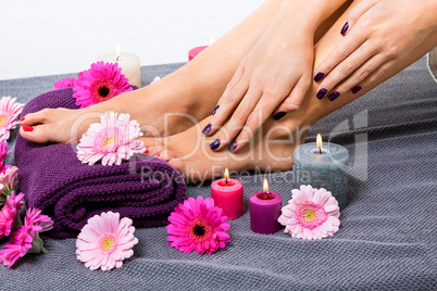 Bare feet of a woman surrounded by flowers