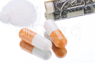 illegal pharmaceutical pills and drugs money on mirror