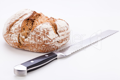 fresh baked grain bead and knife isolated
