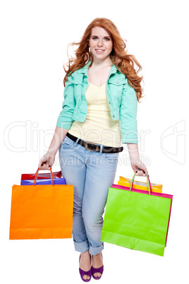 smiling young redhead girl with colorful shoppingbags