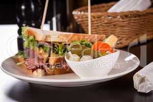 Delicious pastrami club sandwich and pickles