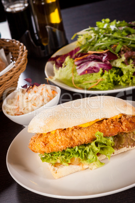 Burger with golden crumbed chicken breast