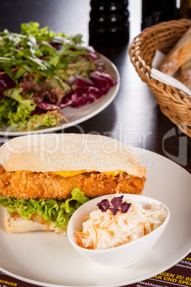 Burger with golden crumbed chicken breast