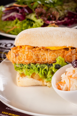 Burger with golden crumbed chicken breast