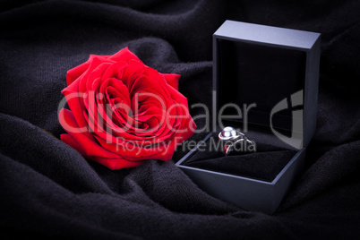red rose and diamond ring in a box