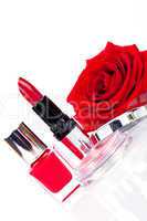 Fashionable cosmetics with a fresh red rose