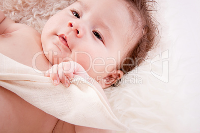 cute little baby infant toddler on white blanket portrait