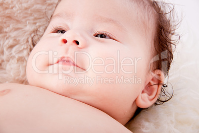 cute little baby infant toddler on white blanket portrait