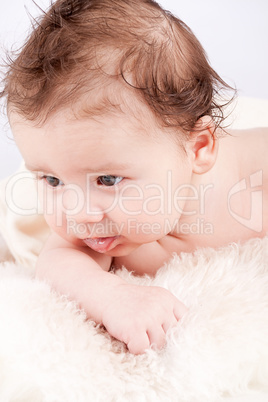 cute little baby infant toddler on white blanket portrait