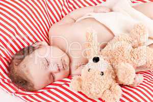 sleeping cute little baby on red and white stripes pillow