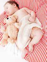 sleeping cute little baby on red and white stripes pillow
