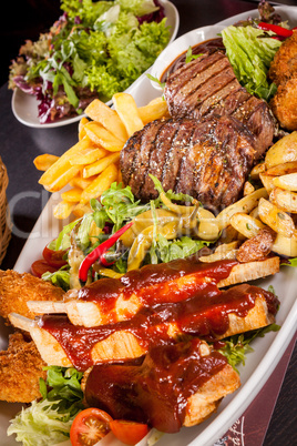 Platter of mixed meats, salad and French fries