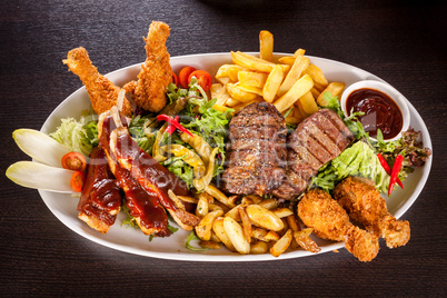 Platter of mixed meats, salad and French fries