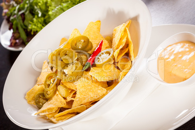 Nachos with cheese sauce and chilli pepperoni