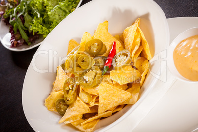 Nachos with cheese sauce and chilli pepperoni