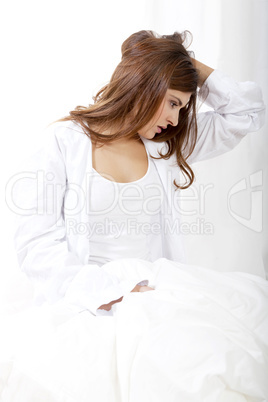 brunette woman in bed sunday morning