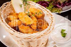 Crumbed chicken nuggets in a basket