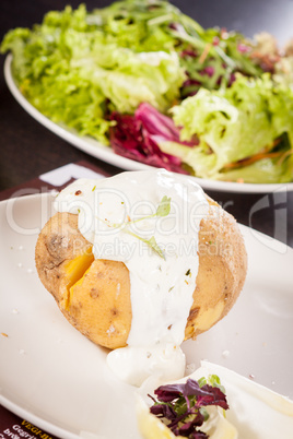 Baked jacket potato with sour cream sauce