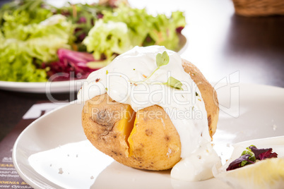 Baked jacket potato with sour cream sauce