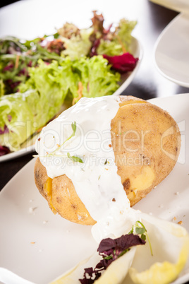 Baked jacket potato with sour cream sauce