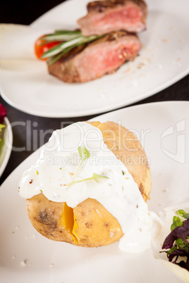 Baked jacket potato with sour cream sauce