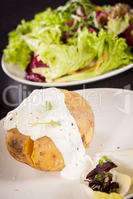 Baked jacket potato with sour cream sauce