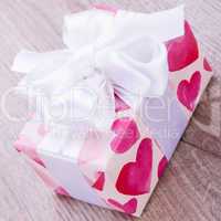 Pretty Valentines gift with hearts on the giftwrap