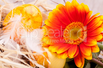 Vivid orange Easter egg with a gerbera and rose