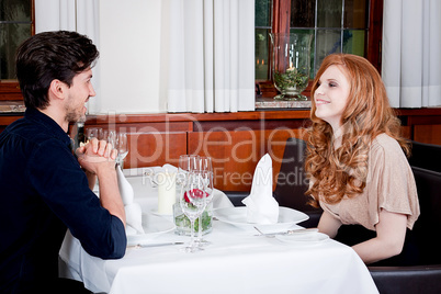 happy smiling couple in restaurant