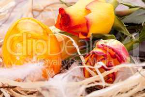 Vivid orange Easter egg with a gerbera and rose