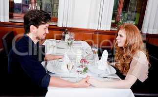 happy smiling couple in restaurant celebrate