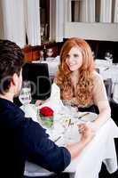 happy smiling couple in restaurant celebrate