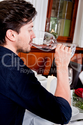 couple drinking red wine in restaurant