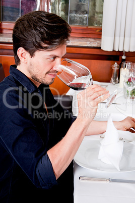 couple drinking red wine in restaurant