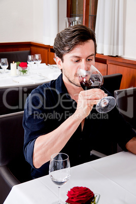 couple drinking red wine in restaurant