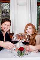 couple drinking red wine in restaurant