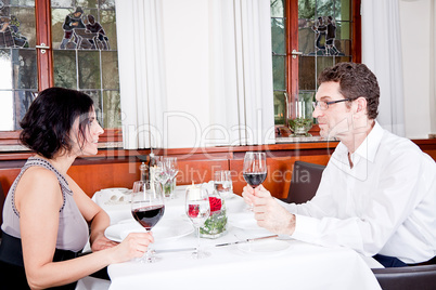 couple drinking red wine in restaurant