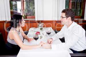 happy smiling couple in restaurant celebrate