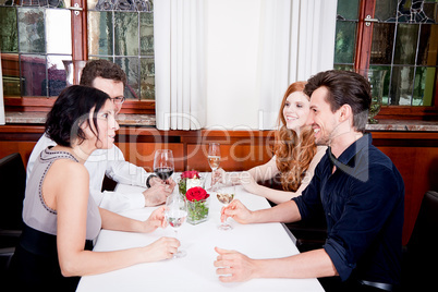 smiling happy people in restaurant