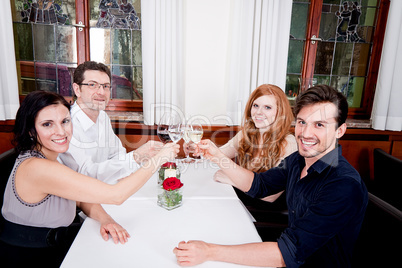 smiling happy people in restaurant