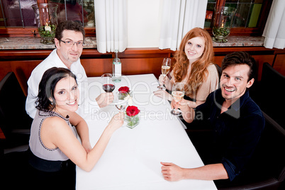 smiling happy people in restaurant