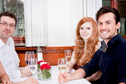 smiling happy people in restaurant