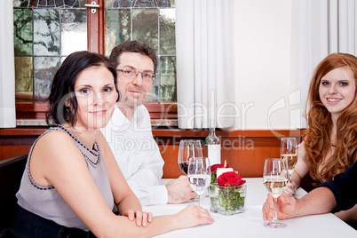 smiling happy people in restaurant